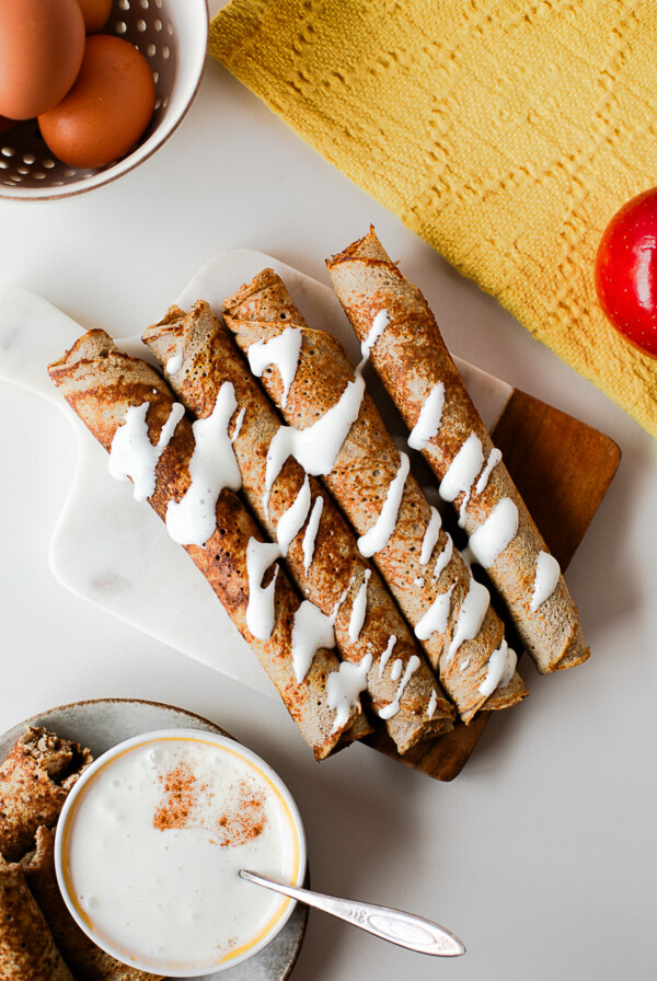 Close-up of apple crepe roll ups drizzled with cottage cheese honey dip