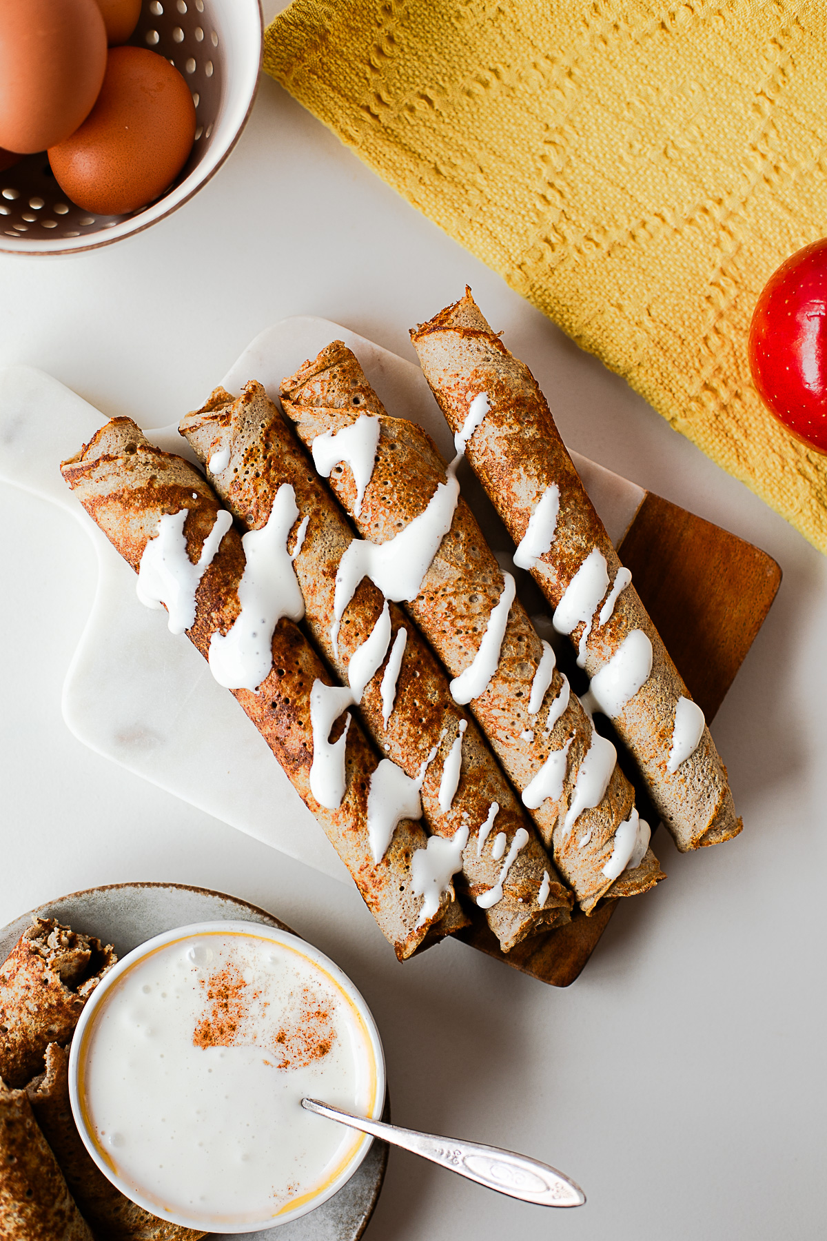 Close-up of apple crepe roll ups drizzled with cottage cheese honey dip
