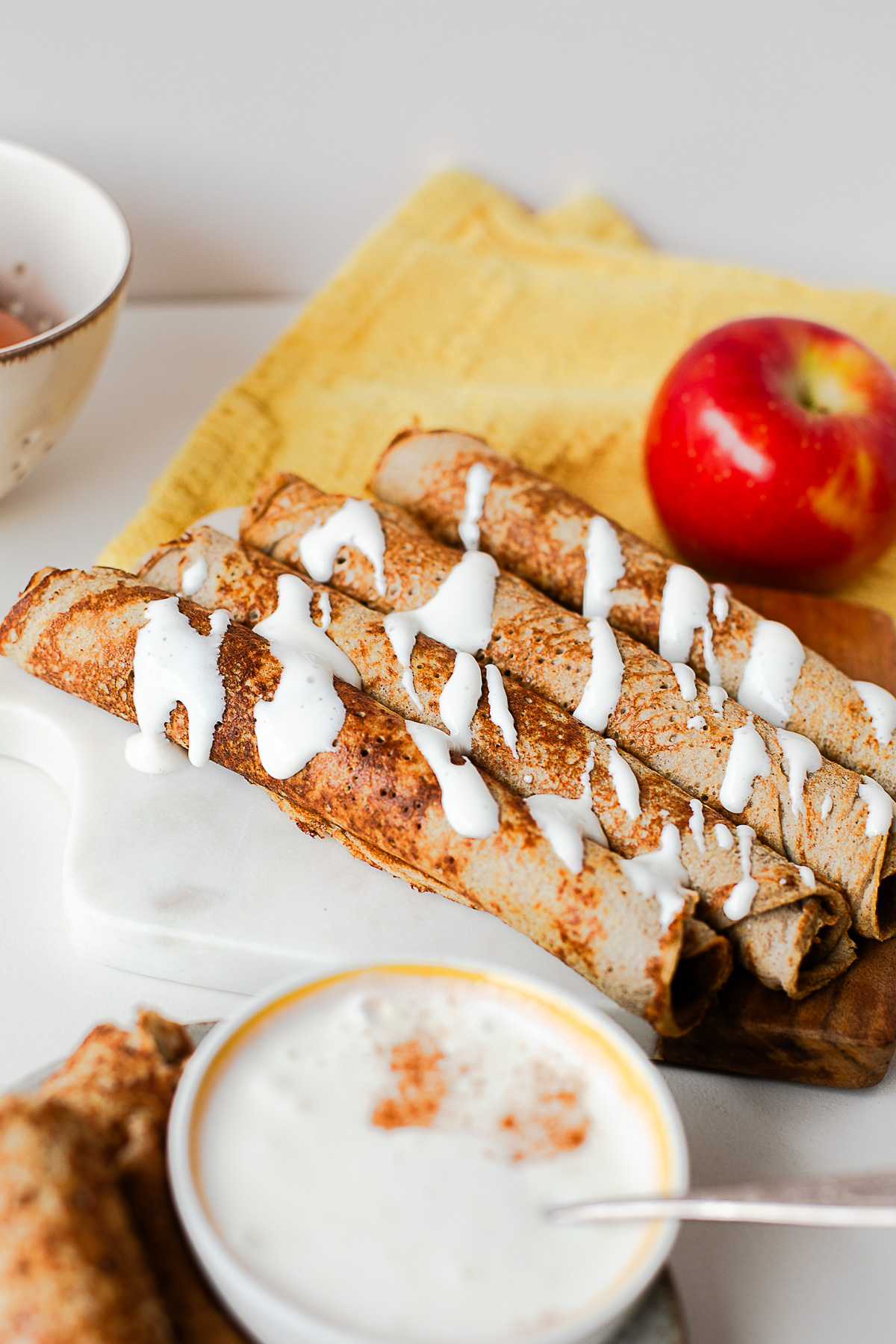 Apple crepe roll ups drizzled with honey dip and dusted with cinnamon