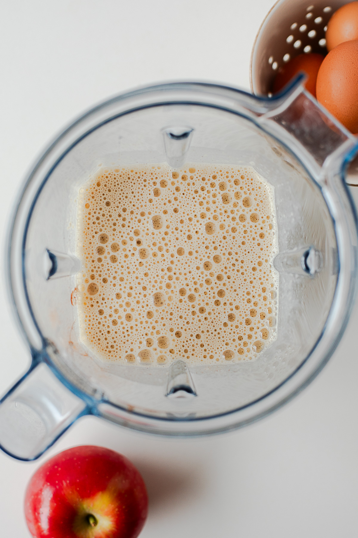 Apple crepe batter pulsed with small apple pieces in a blender