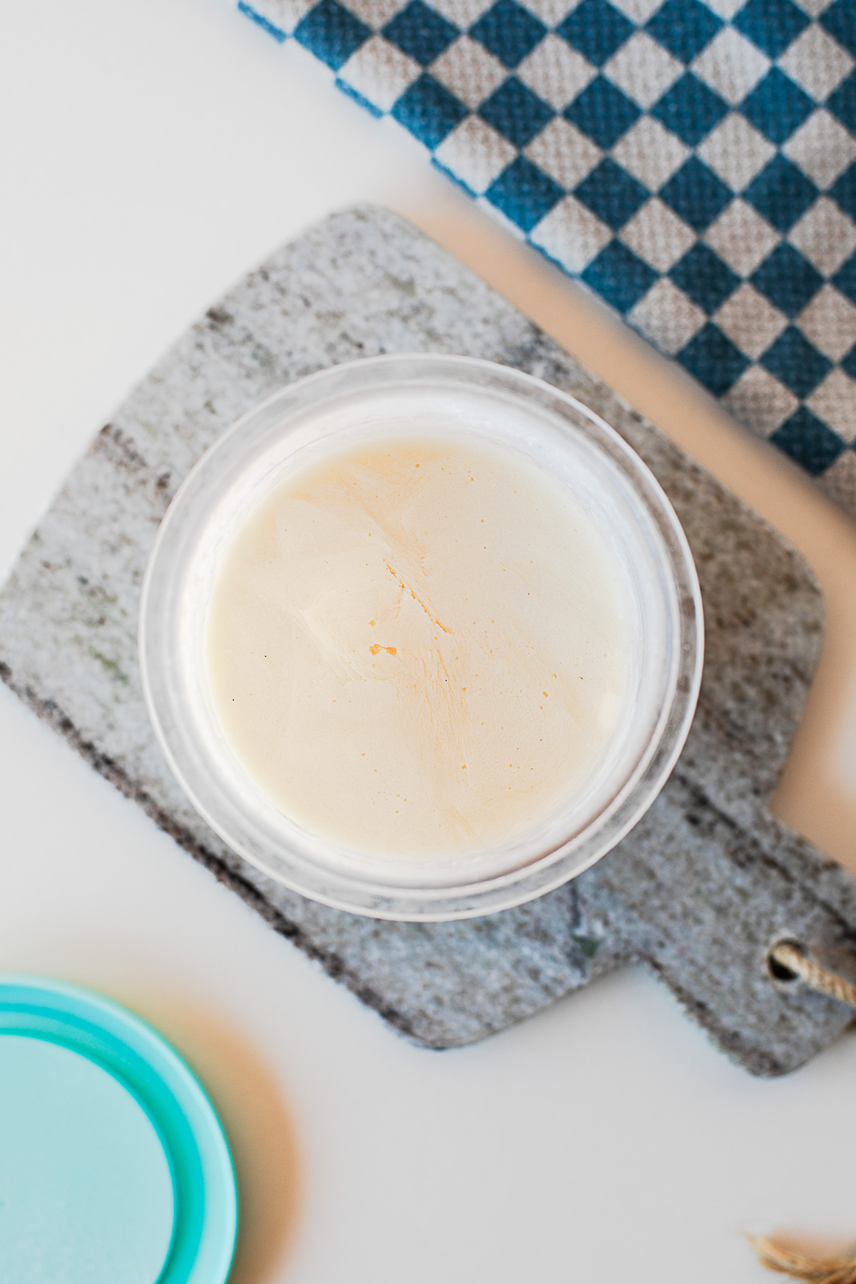 Overhead shot of frozen protein ice cream in the Ninja Creami container ready to spin.