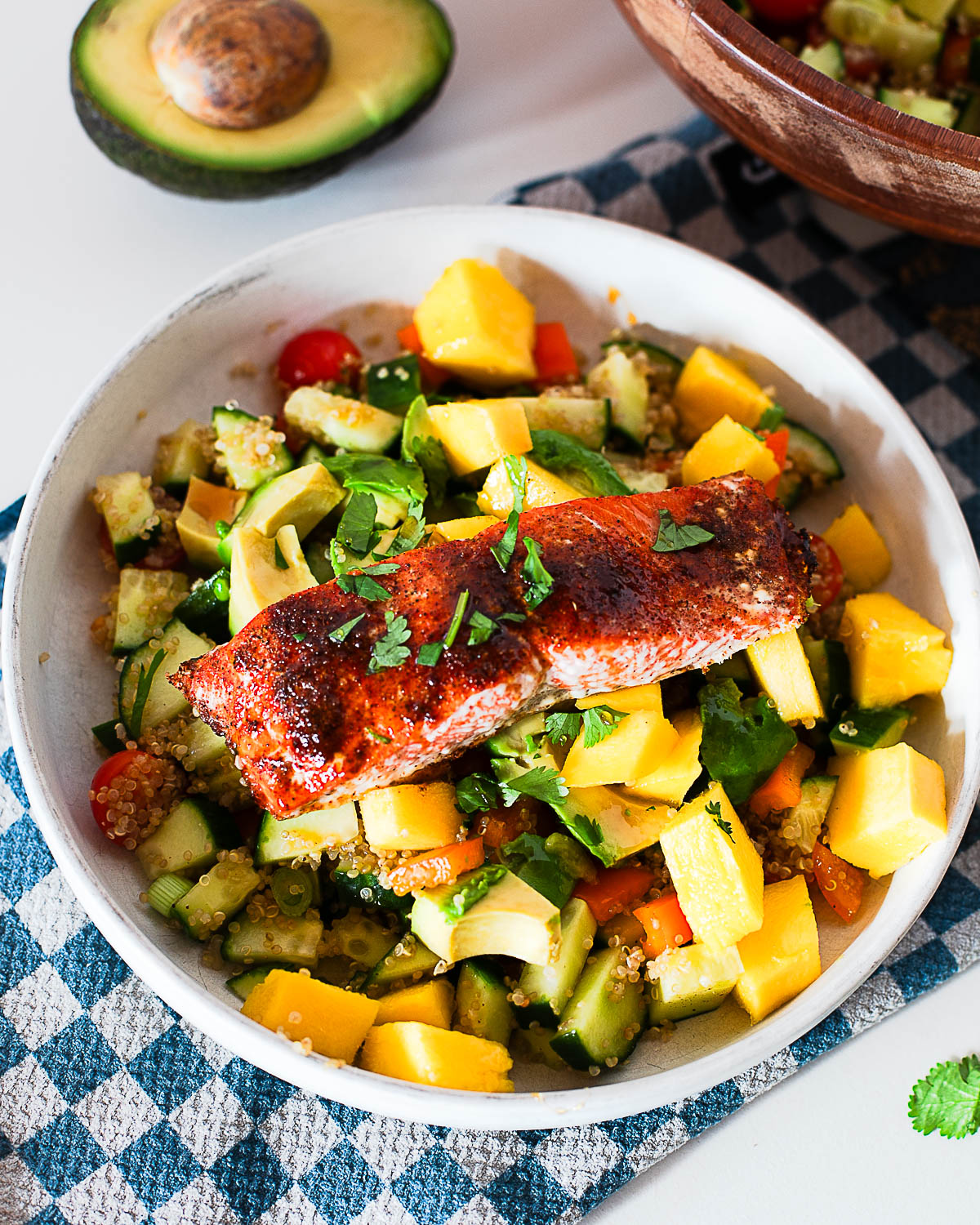 High protein hot honey salmon bowl with quinoa, mango, avocado and fresh herbs