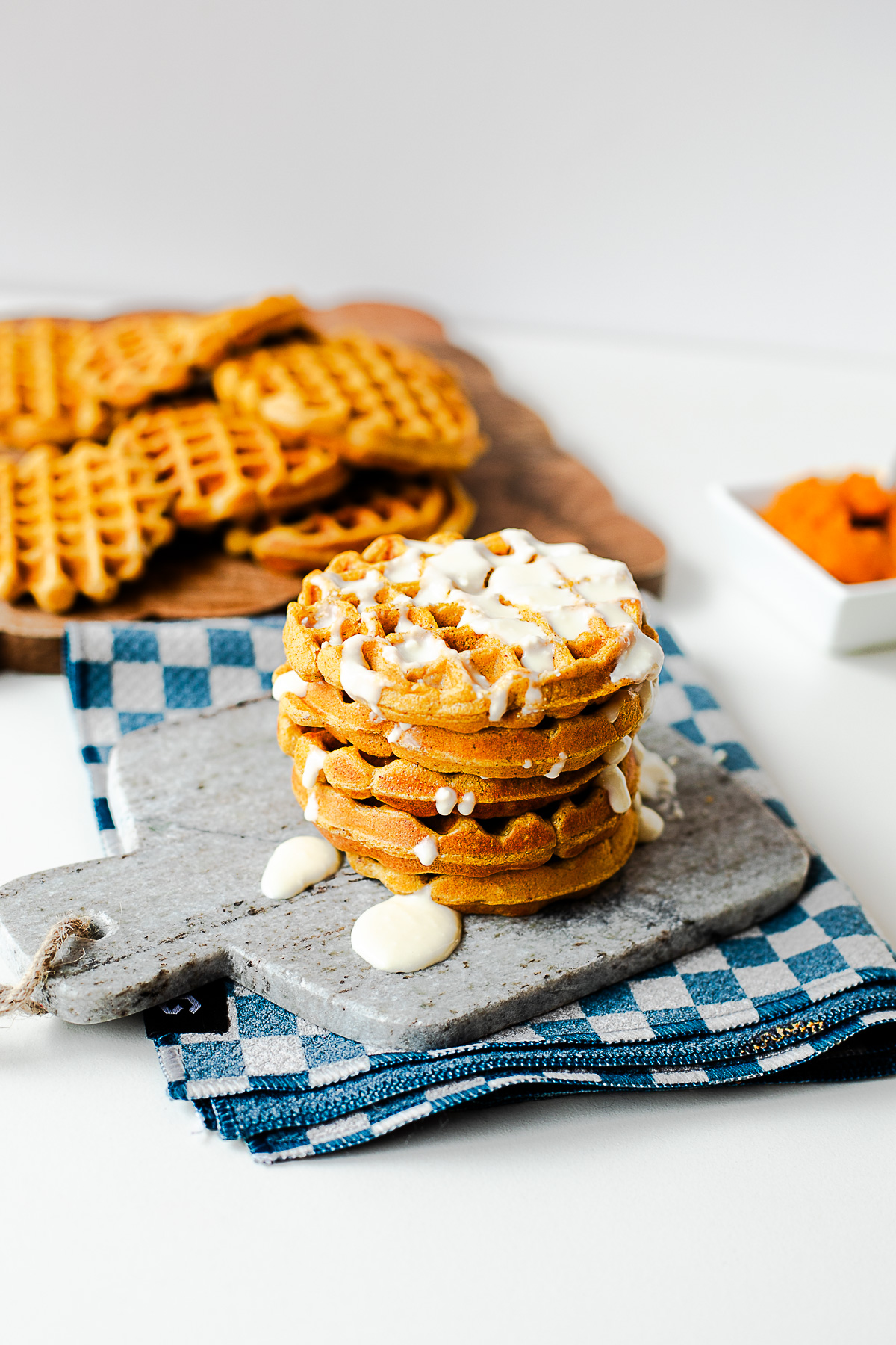 Pumpkin cottage cheese waffles with honey drizzle on a marble board